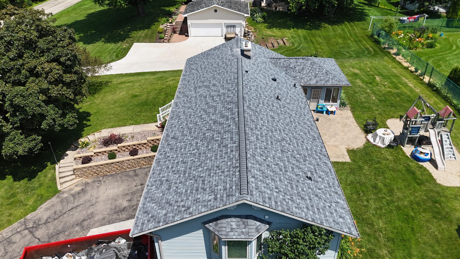 An aerial view of a house with a new roof.