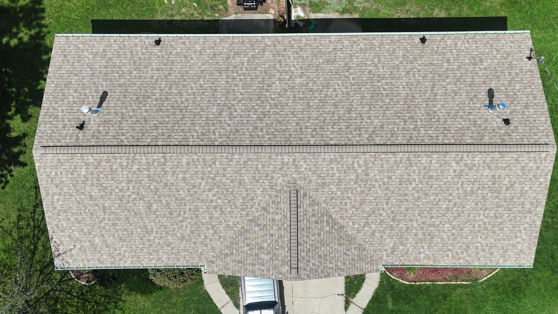 an aerial view of a roof with a roofer working on it .