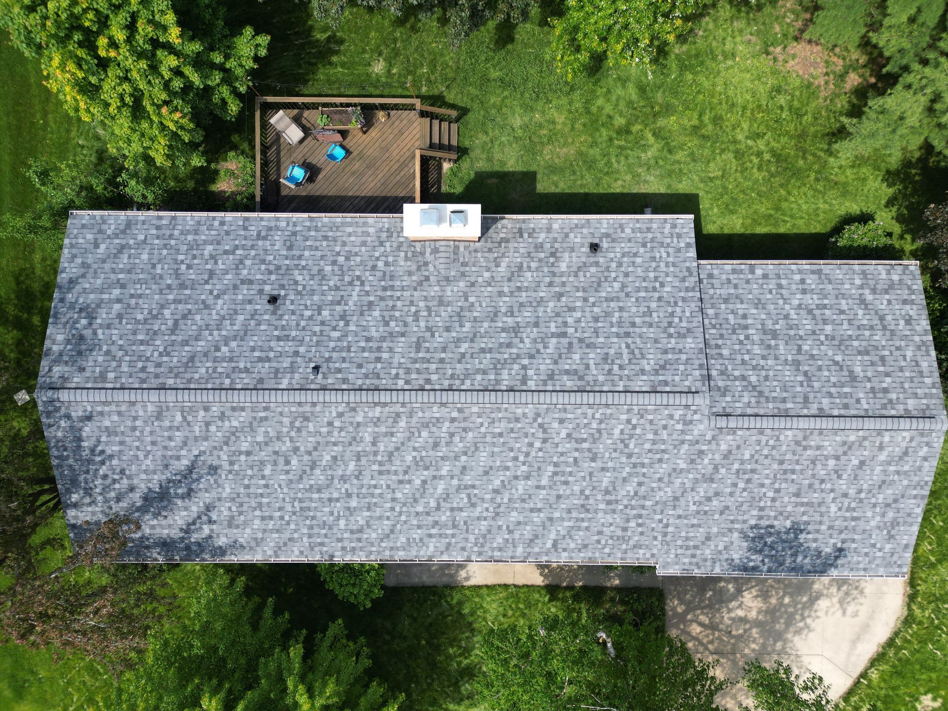 An aerial view of a house with a roof and a deck.