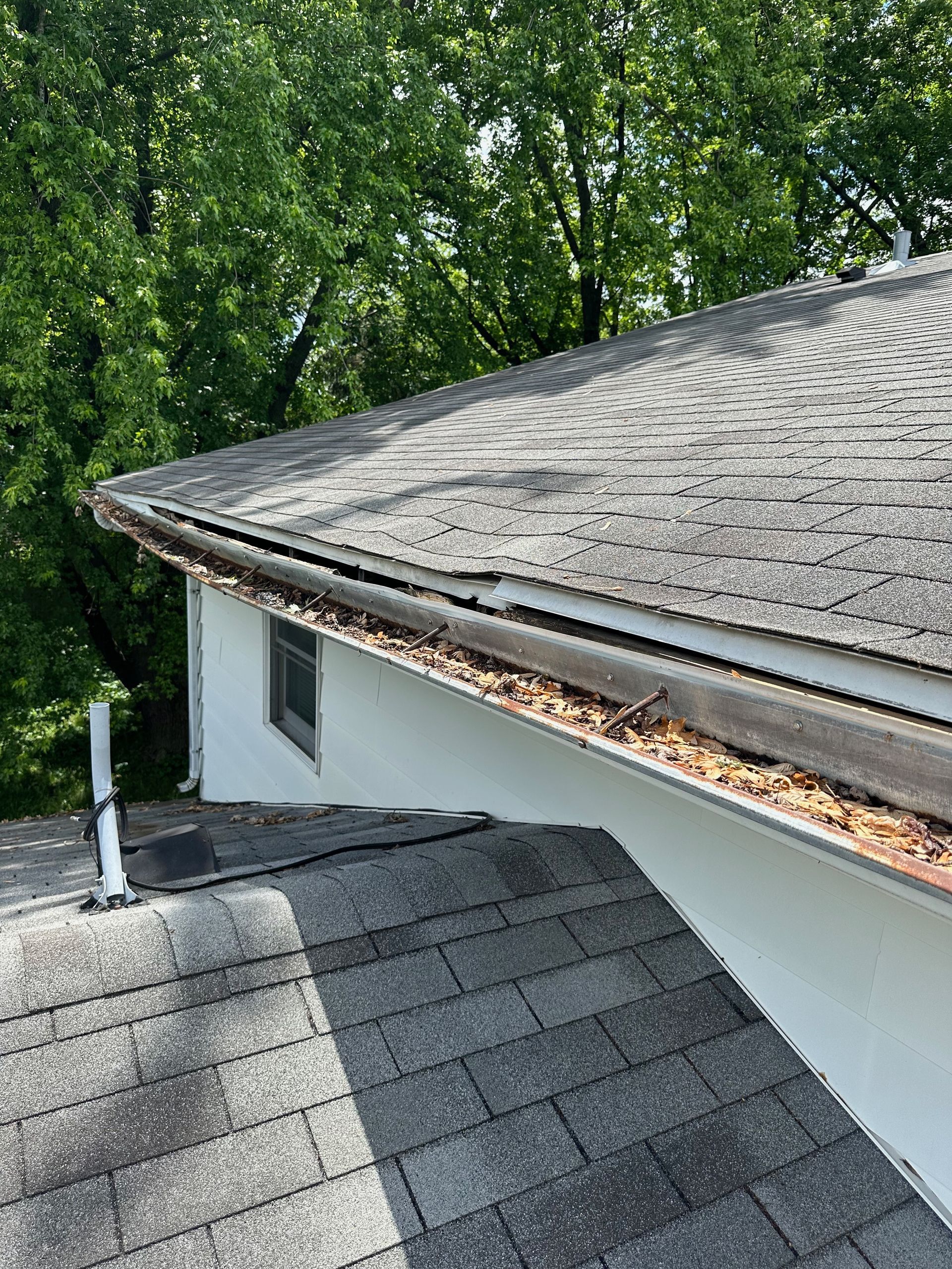 A close up of a roof with a gutter on it.