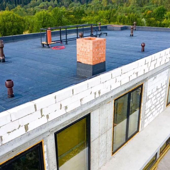 an aerial view of a building with a chimney on the roof .