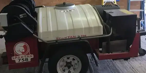 A red and white trailer with a tank on it.