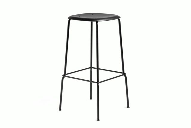 Black metal bar stool with a round seat and four thin legs on a white background
