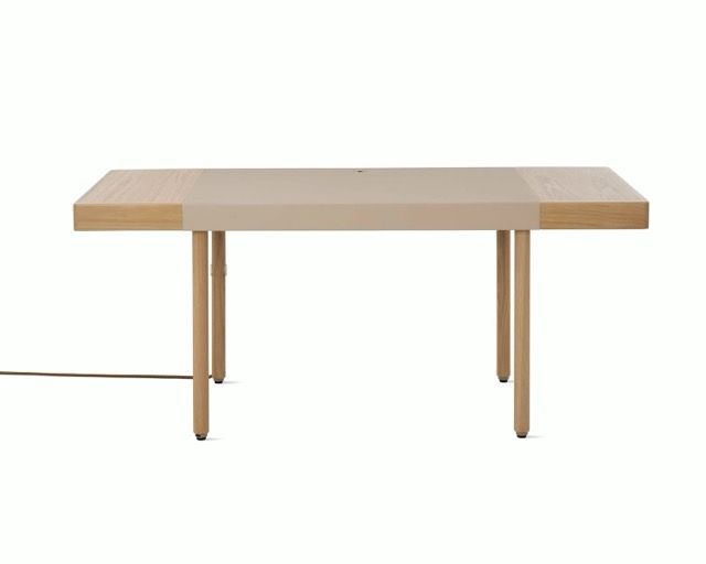 Minimalist wooden table with a light wood top and tapered legs on a white background