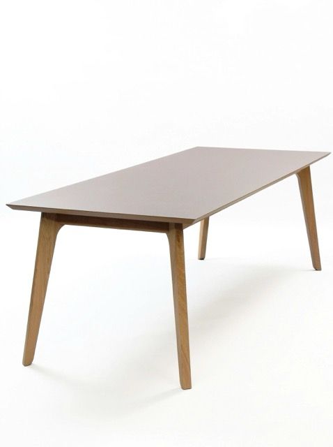 Modern rectangular wooden dining table with tapered legs on a white background