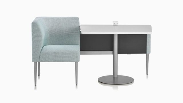 Modern desk with gray upholstered chair and round pedestal base, shown on a white background