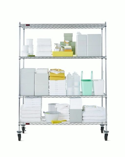 Metal wire shelving cart with four shelves and caster wheels on a white background