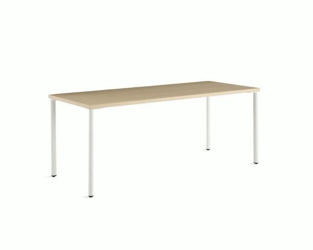 Minimalist light wood rectangular desk with white legs on a white background