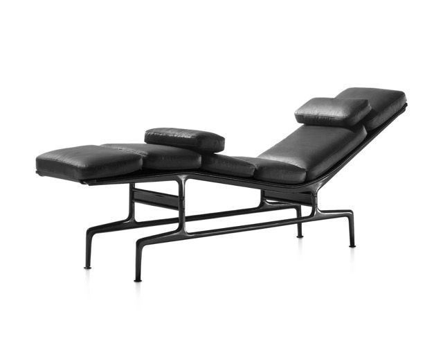 Black adjustable massage table with padded headrest and arm supports on metal frame