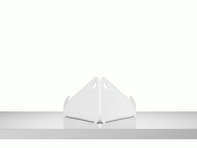 White folded triangular paper object on a light gray surface against a white background