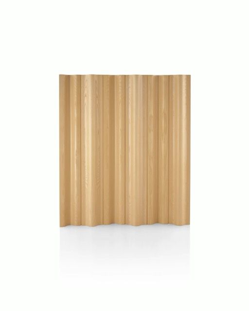 Beige pleated curtain hanging against a white background