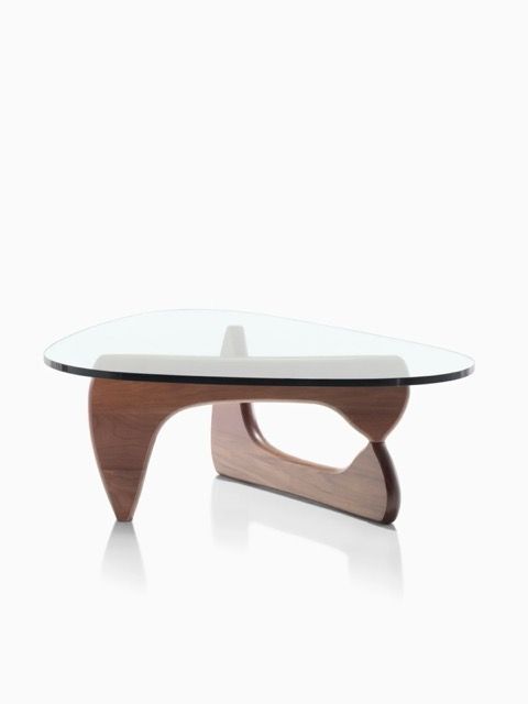 Modern glass coffee table with curved wooden legs on a white background