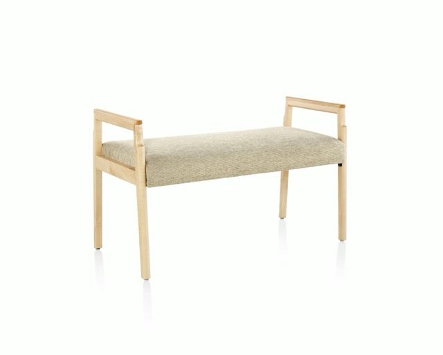 Minimal beige upholstered bench with light wood legs and armrests on a white background