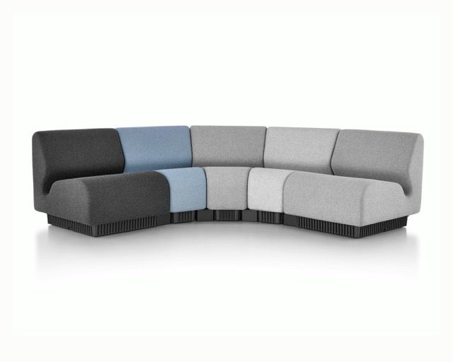 Modern curved modular sofa in black, blue, and gray fabric on a white background