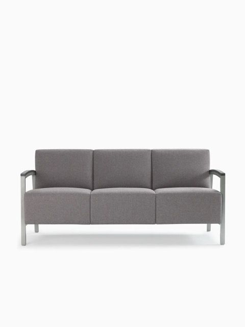 Gray three-seat sofa with metal arms on a white background