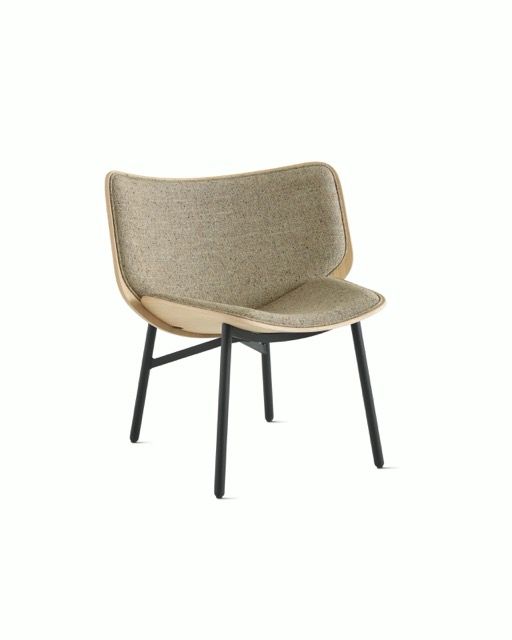 Beige upholstered lounge chair with black legs on a white background.