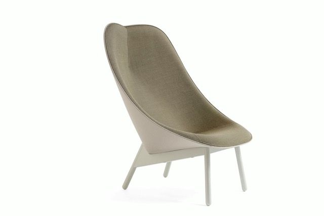 Modern beige upholstered lounge chair with white legs, isolated on a white background