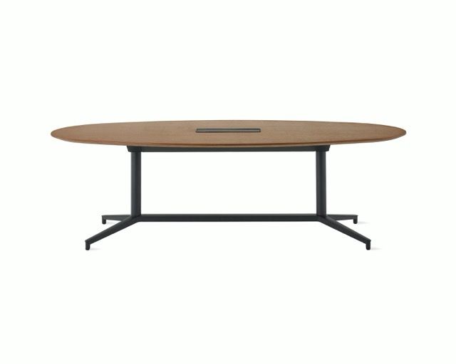 Oval beige conference table with dark metal legs and two cable grommets