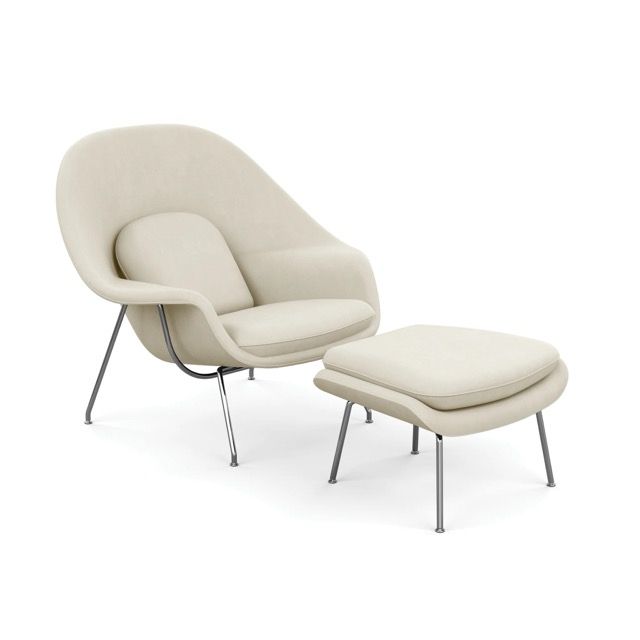 Cream upholstered lounge chair with matching ottoman on thin metal legs, isolated on white background