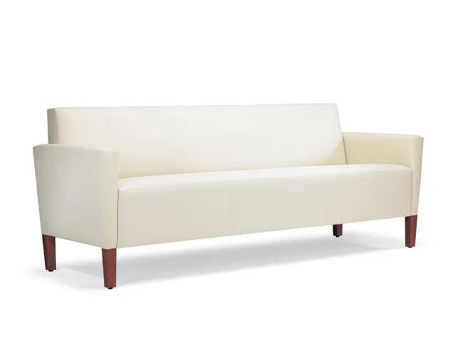 Cream-colored modern sofa with wood legs, isolated on white background