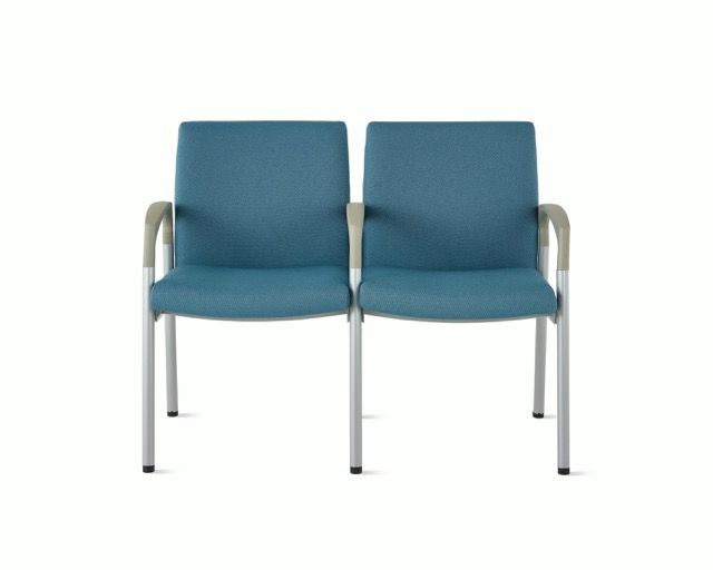 Two blue upholstered chairs with metal legs on a white background