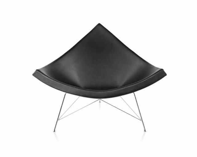 Black modern lounge chair with a curved seat and thin metal legs on a white background