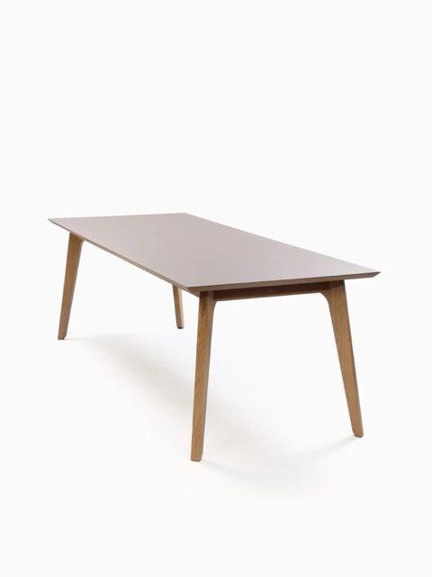 Modern rectangular wooden dining table with tapered legs on a white background
