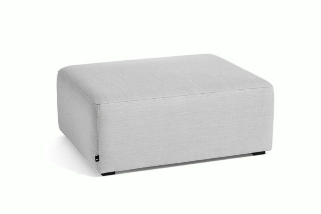 Light gray upholstered ottoman with rounded edges on a white background