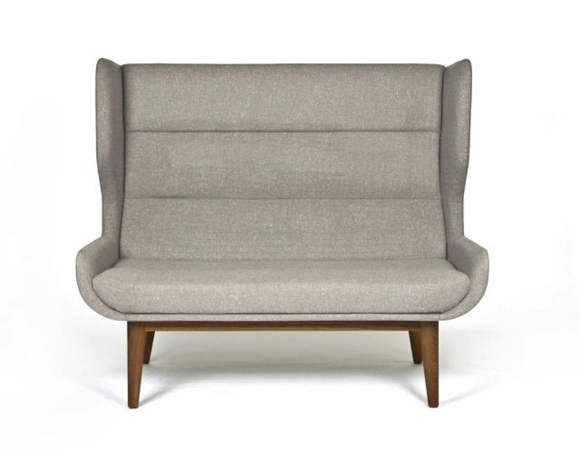 Gray upholstered lounge chair with wooden legs, front view on a white background