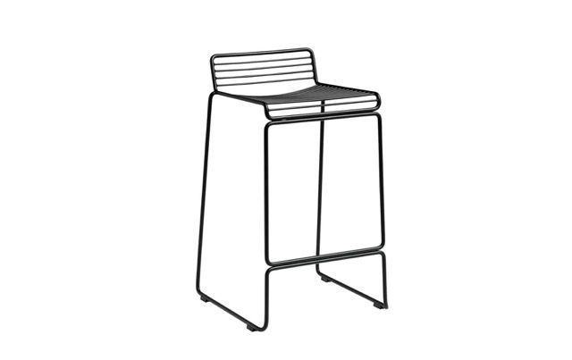 Black line drawing of a modern bar stool with a slatted backrest and angled legs