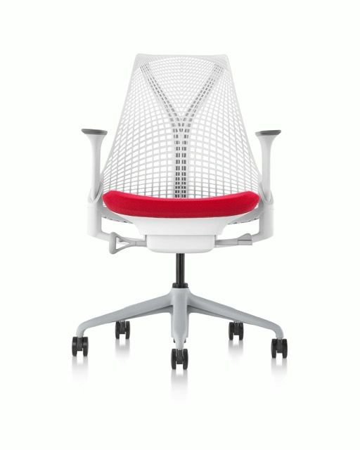 White mesh office chair with red seat cushion and chrome base on casters, front view