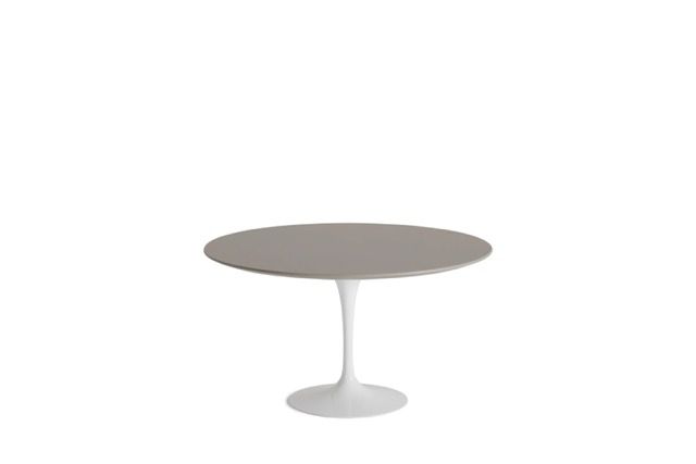 Minimalist round gray pedestal table on a white background