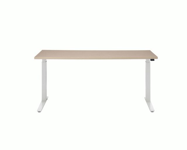 Minimalist white desk with light wood top on a plain white background