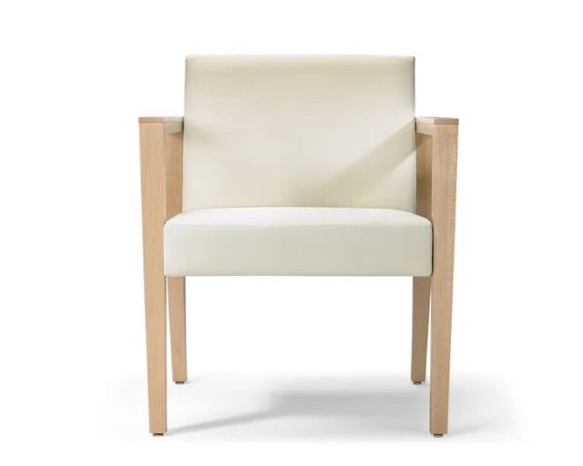 Modern cream upholstered armchair with light wood frame on a white background