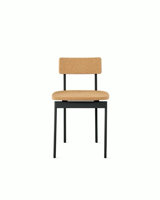 Tan woven-back chair with beige seat and black metal legs on a white background