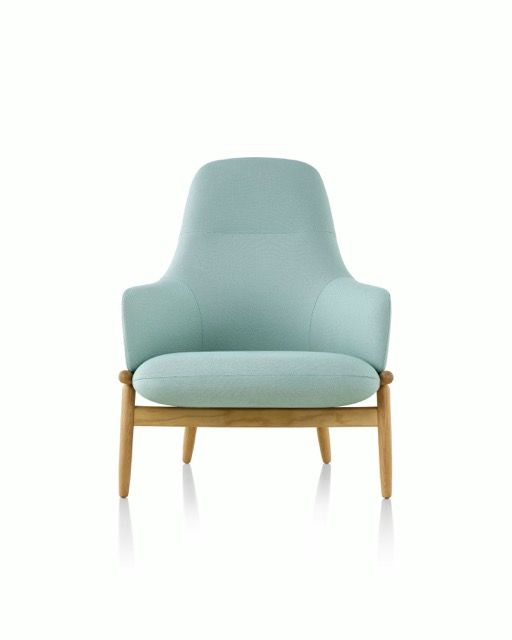 Light blue upholstered armchair with wooden legs on a white background
