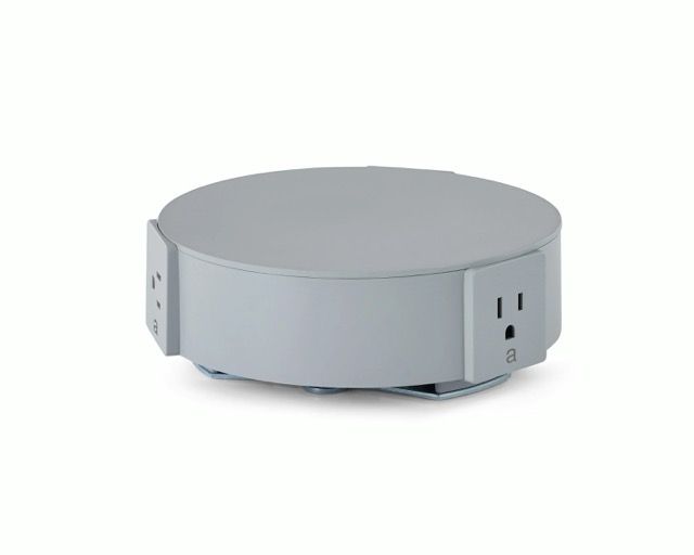 Round gray smart outlet or power hub on a white background