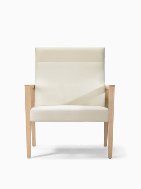 Modern cream upholstered armchair with light wood frame, isolated on white background