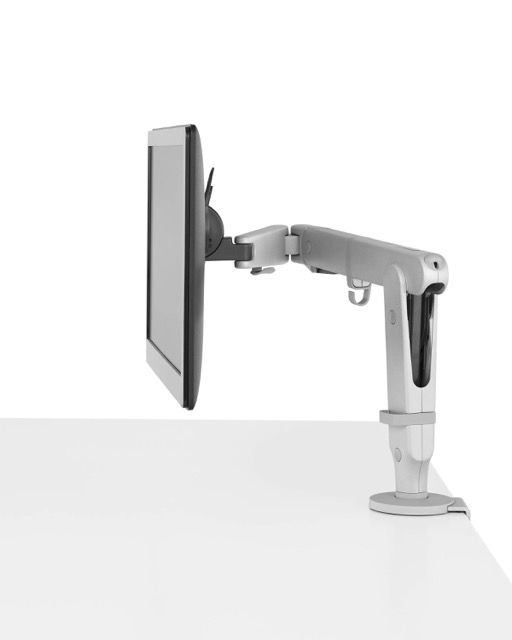 Tablet mounted on a silver adjustable arm stand on a white surface