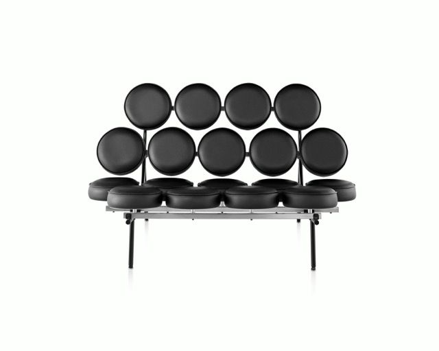 Black modern bench with eight round backrests and black cushioned seats on metal legs