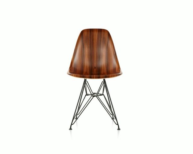 Wooden lamp with tapered shade on a thin metal tripod base against a white background