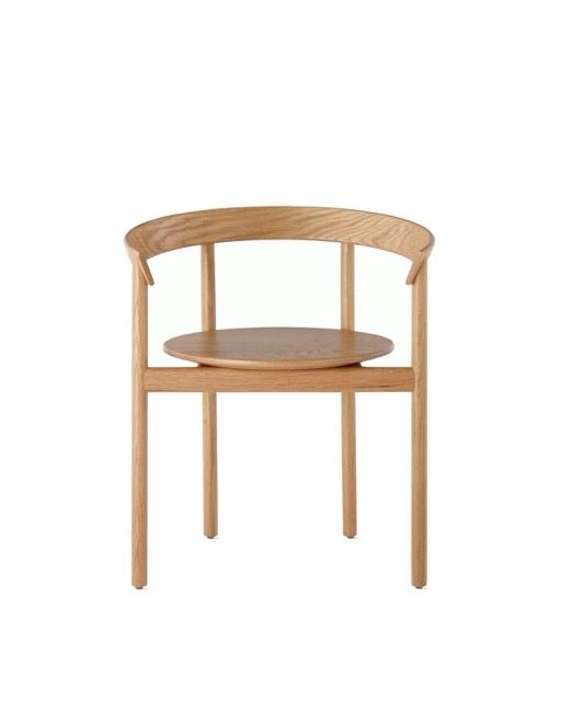 Light wood chair with a curved back and round seat on a white background
