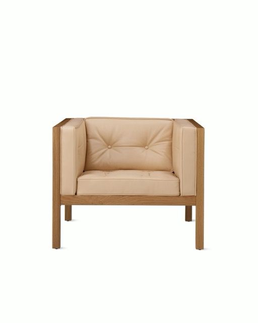 Beige upholstered armchair with wooden frame on a white background