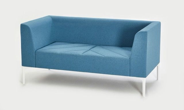 Blue upholstered loveseat with white metal legs on a white background