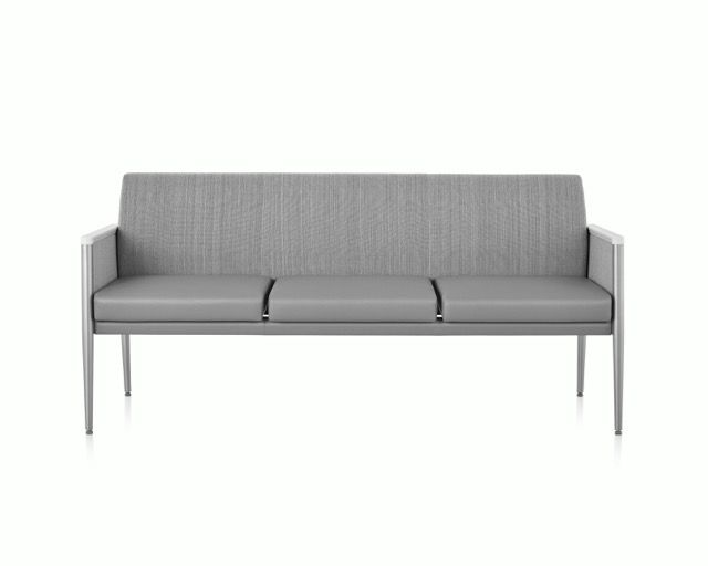 Gray upholstered three-seat sofa with slim metal legs on a white background