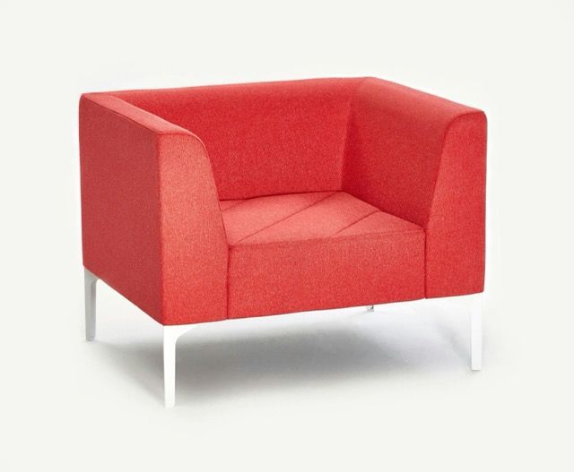 Red upholstered armchair with white legs on a light background