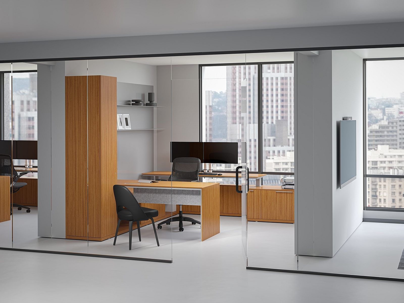Modern office interior with wooden desk, chair, monitor, and city views through large windows