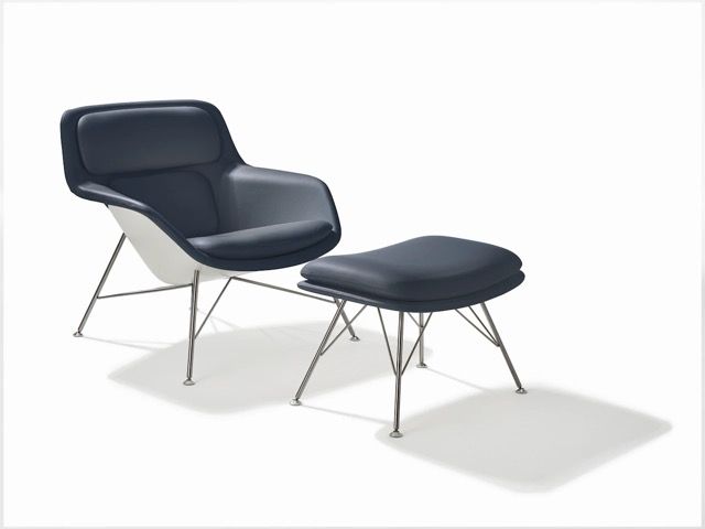 Black modern lounge chair with matching ottoman on a white background