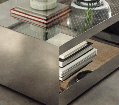 Modern glass coffee table with stacked books, a plant, and a cup in a living room