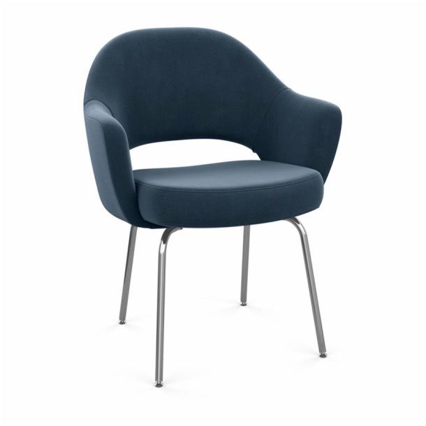 Blue upholstered armchair with chrome legs on a white background